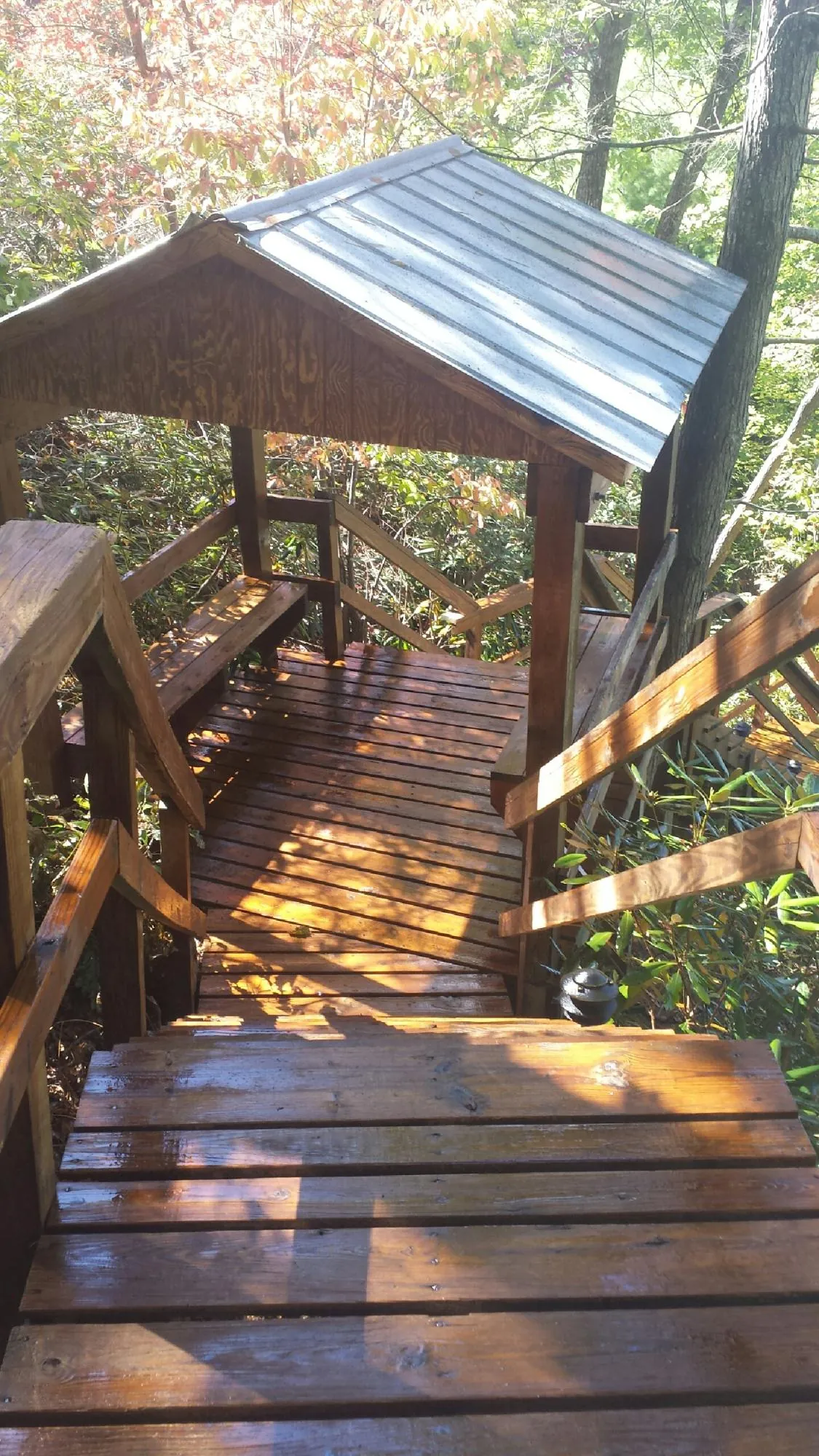 Freshly stained wood walkway and covered shelter with a metal roof in Garrattsville